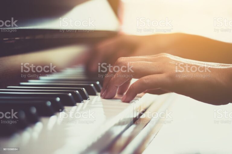 Close up of happy woman's hand playing the piano in the morning